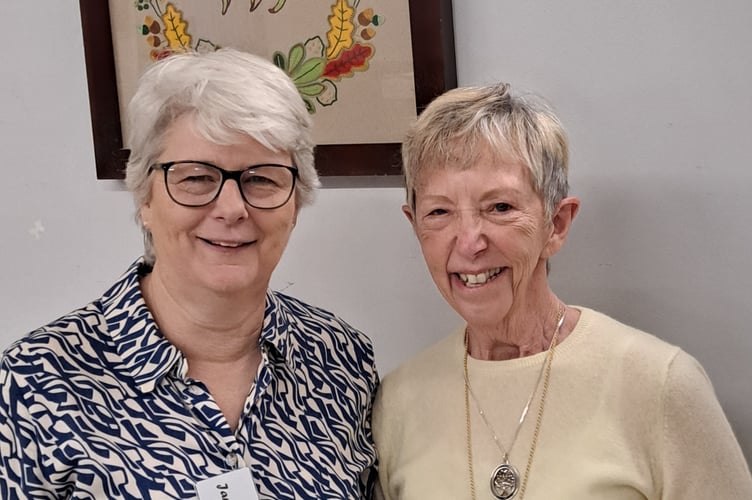 Outgoing President Jane Burrow, left, with newly elected Tedburn WI President Hilary Pook.