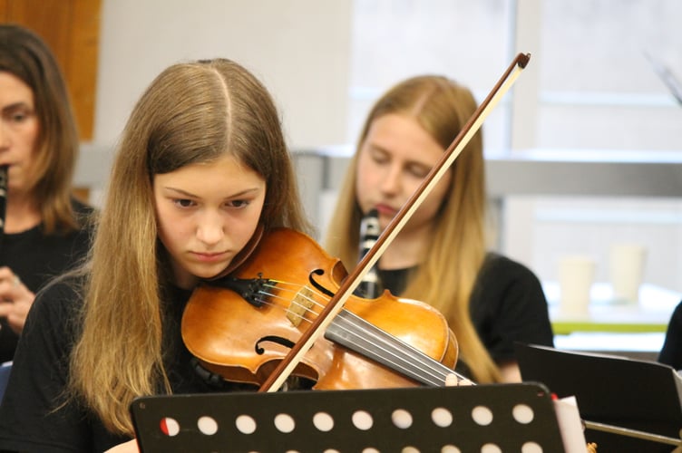 Concentration on the face of one of the Youth Orchestra performers. AQ 1302