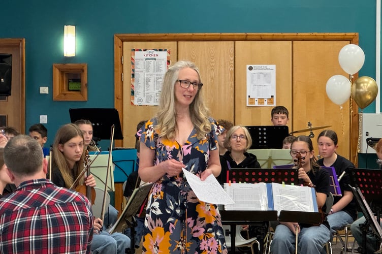 Alison Golby, Musical Director, Crediton Youth Orchestra addressing the audience. AQ 0984