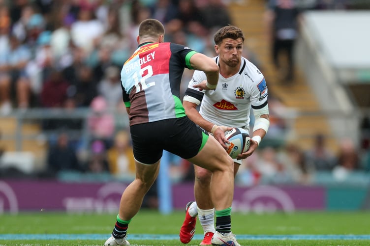 Henry Slade of Exeter Chiefs runs while under pressure from Bryn Bradley of Harlequins