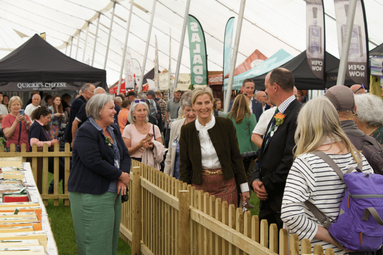 Sophie, Duchess of Edinburgh being shown the prizewinning cheeses in the food tent