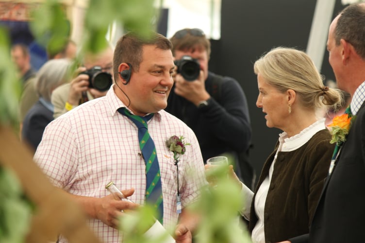 Pete Rich, steward in the Cider area of the Food and Drink tent offered Sophie, the Duchess of Edinburgh, a sample of prizewinning cider at the Devon County Show. AQ 1341
