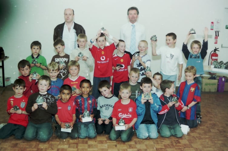 Crediton Saints FC Under 7s with their trophies and coaches Jim Clawson, left, and Tony Leach in May 2006. DSC01335
