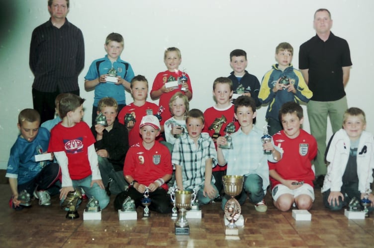 Crediton Saints FC Under 9s with their trophies and coaches Clive Eginton, left, and Mike Vinnicombe in May 2006. DSC01340
