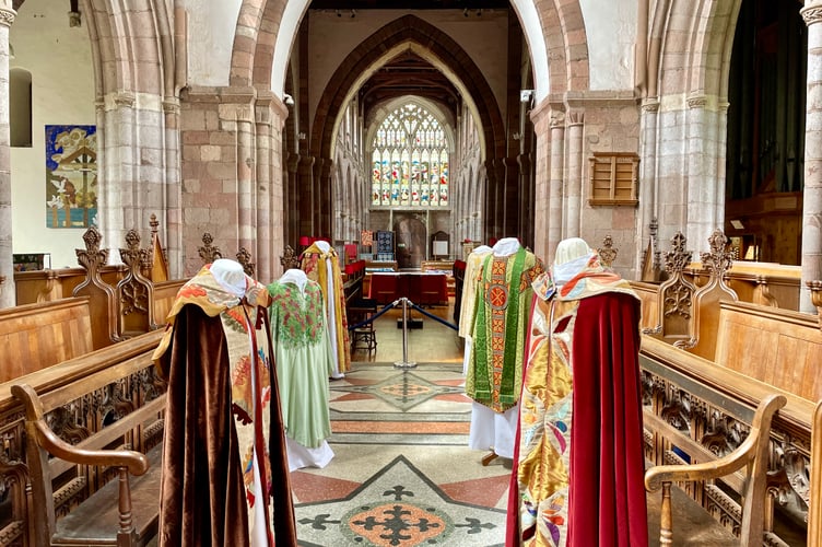 A display of church vestments inside Crediton Parish Church
