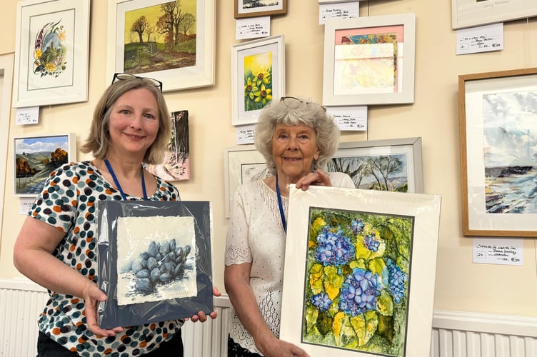 Nicola Hussey and Lola Gill from Newton St Cyres Art Group with examples of their work and of other group members
