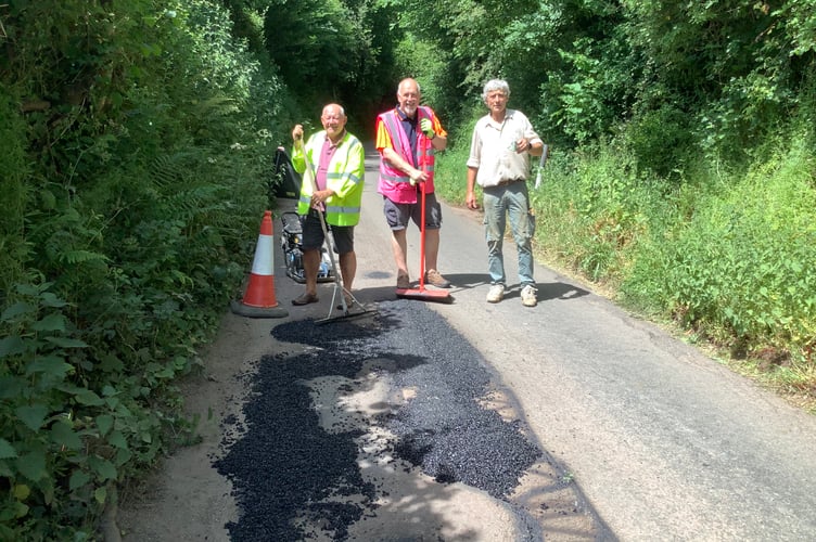 Crediton County Councillor Jim Cairney, Steve Huxtable (Mayor of Crediton) and Phil Hancock (Lengthman of Hittisleigh) at work repairing potholes on Neopardy Hill recently in the hot weather.