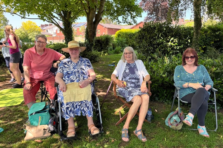 Some of those who attended the service and sheltered in the Jubilee Gardens. AQ 1664