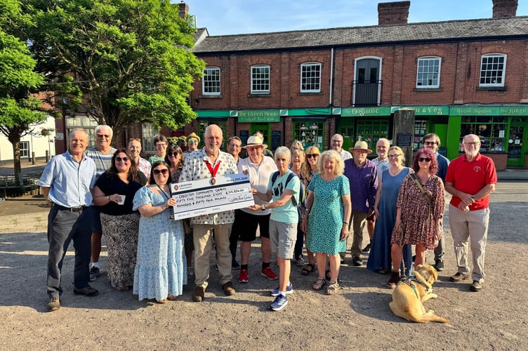 Cllr Steve Huxtable, the Mayor of Crediton, holding the cheque with some of the representatives from group which received funding.  AQ 1867
