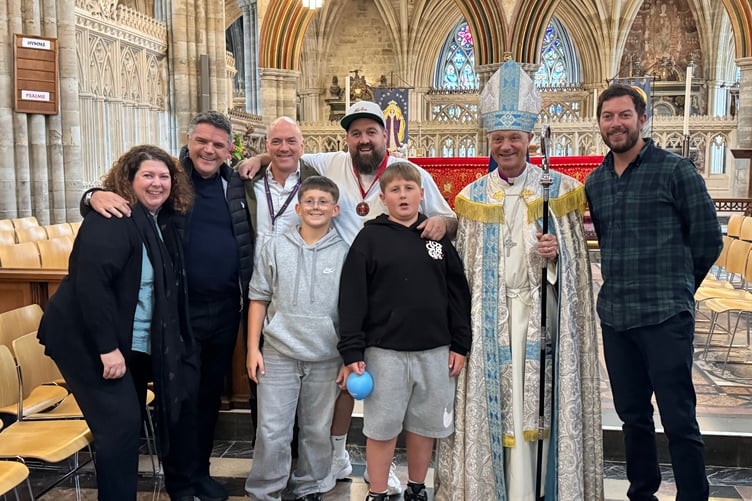 One of the award recipients with his family and the Bishop of Exeter. AQ 2813