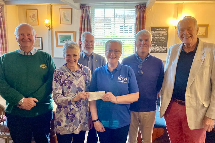 Rear from left, swimmers Paul Radnor, Fred Oliver, Paul Butt and Paul Evans; front from left, Rotary President Jane Brimacombe, Sue Perkins of Force Cancer Charity