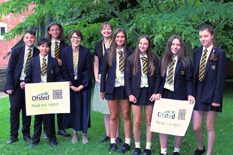 Headteacher Paula Smith, fourth from left, and Deputy Headteacher Alex Blagden with QE students