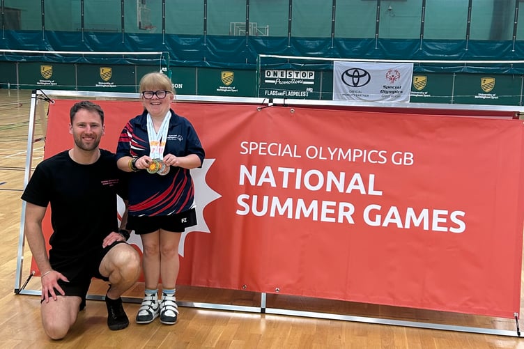 Dee with her medals and coach Jake Dan.