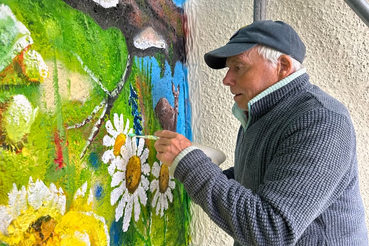 John Hurford, artist, at work on the giant mural in Chulmleigh. AQ 2989
