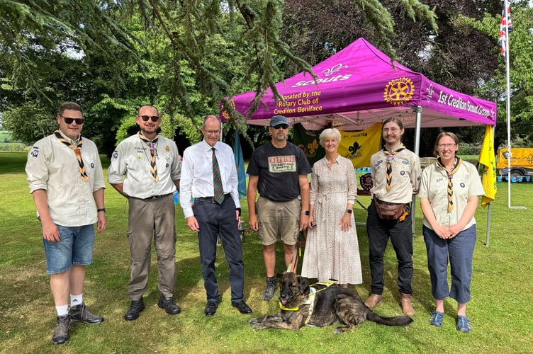 Mid Devon Scout Leaders with Henry and Susan Parker and Richard and his guide dog, Fordy.  AQ 3679

