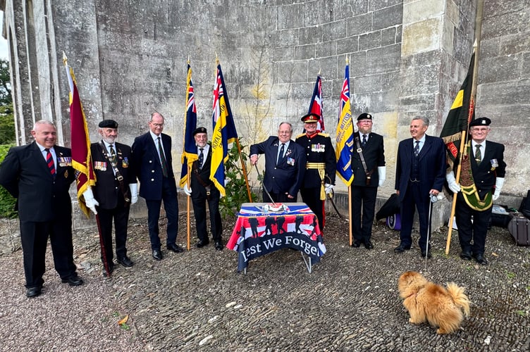 Arnold Vosper, former Crediton RBL chairman, cuts the celebration cake with Major General O’Leary’s sword.  AQ 3626
