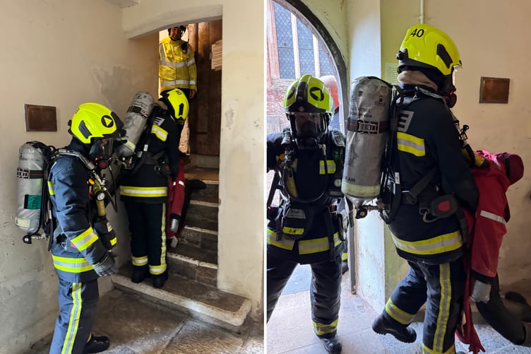 Firefighters reverse down a staircase during a simulated casualty rescue in Crediton Parish Church. AQ 4545/4548