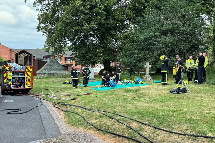 Fire appliances alongside the churchyard at Crediton Parish Church. AQ 4537