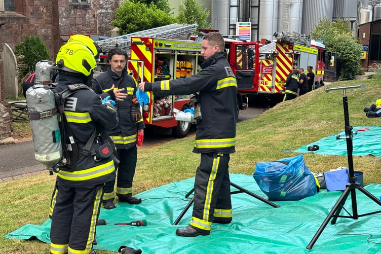 Firefighters in breathing apparatus get ready to enter Crediton Parish Church during the exercise. AQ 4564