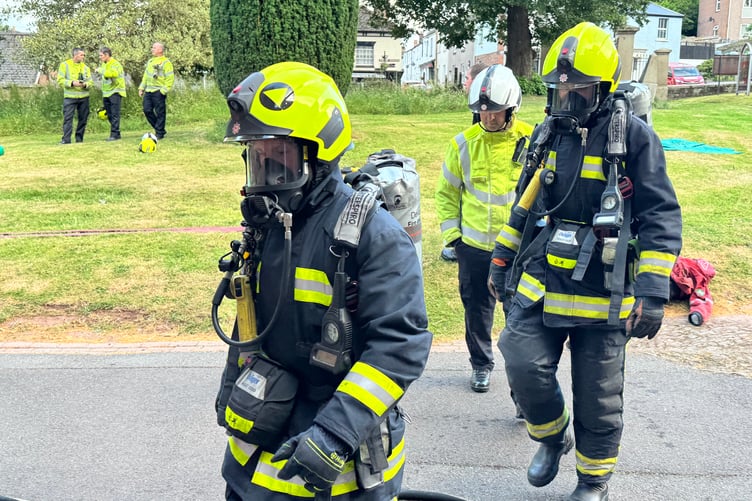 Firefighters in breathing apparatus about to enter Crediton Parish Church during the exercise. AQ 4556