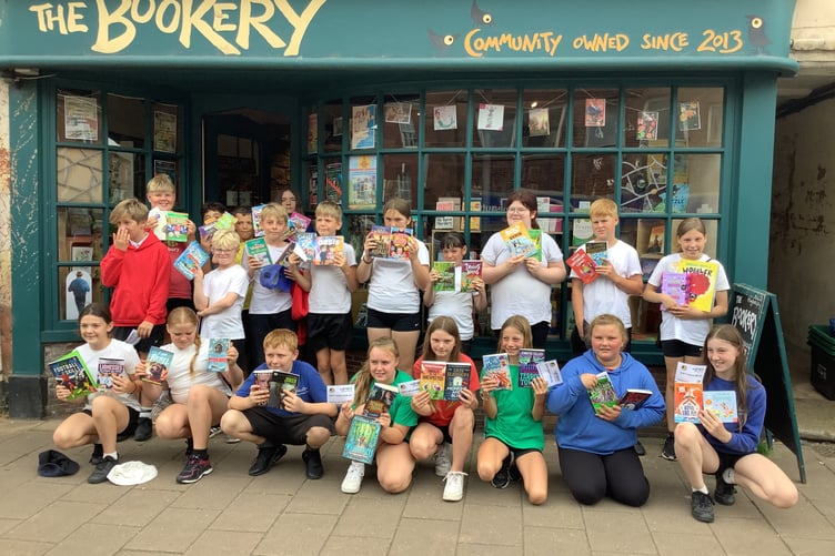 Youngsters with books outside The Bookery on Crediton High Street