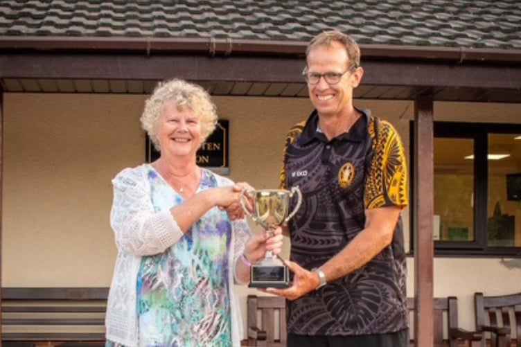 Skipper Simon Saunders being presented with the winning trophy by Sue Sparham