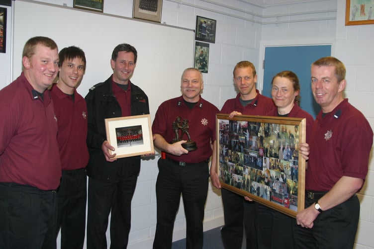 Retiring after 30 years in the fire service, Bob Kestel, centre, received many gifts from colleagues in April 2005. 250-5028_IMG
