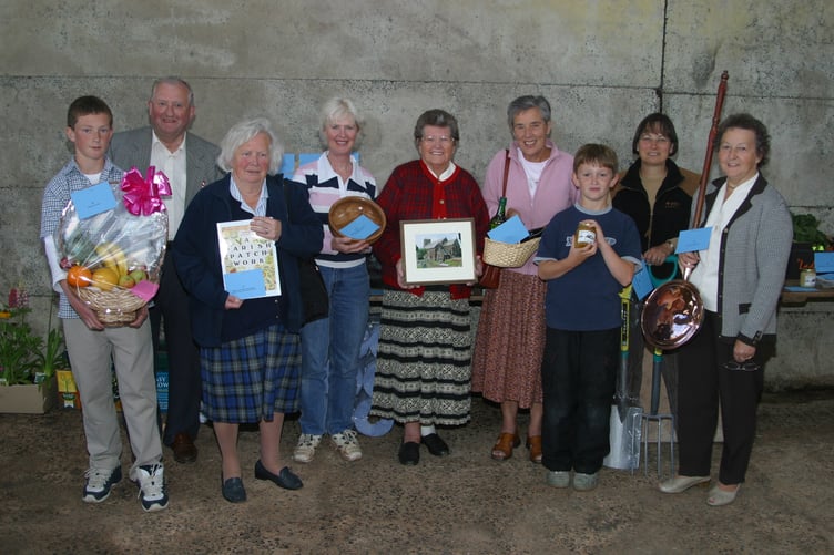 A pledge auction was held at Sandford to raise funds for St Swithun's Church Under Gallery Development project, pictured are helpers with some of the auction items in July 2004. 201-0107_IMG