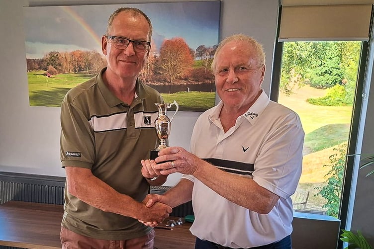 RFC President Trevor Sanders receiving the trophy from Nick Bromell.