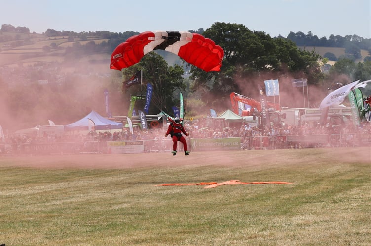 The British Army Parachute Display Team The Red Devils skydived at high speed into the main ring