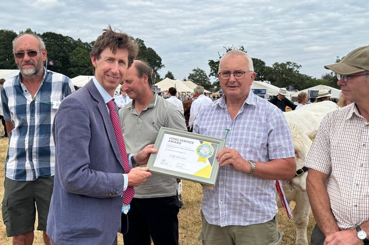 Mid Devon Show: Gary Bulled of Cheriton Fitzpaine received a Long Service Award for his work with Beares from Show President William Heathcoat Amory. AQ 6578