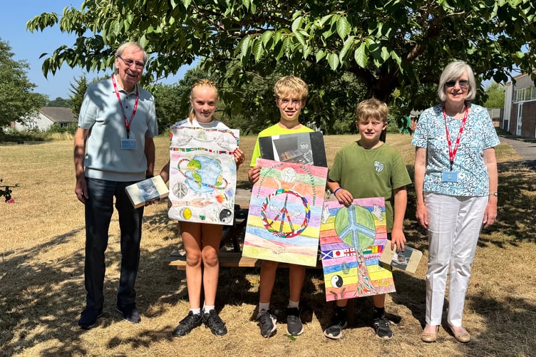 Lion Eric Parkes and Mrs Sue Parkes with the Copplestone School peace poster winner Theo, centre and runners-up Esme and Harry. AQ 5562