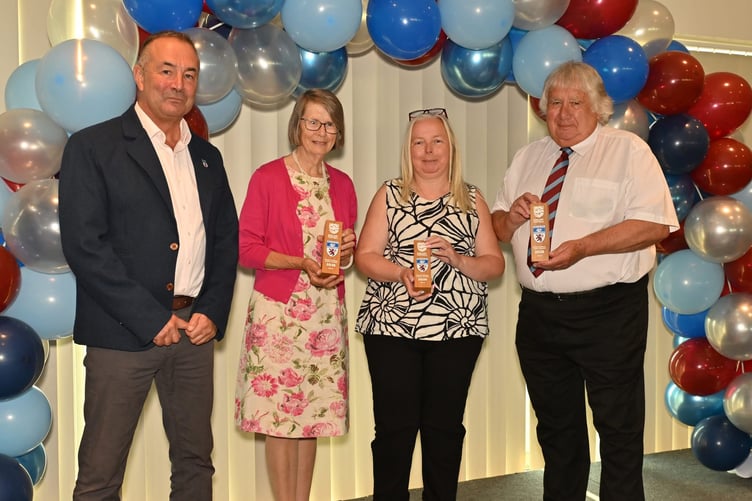 Mary Avery, second left, and two other Devon FA long service award winners on stage at Sandy Park, Exeter.