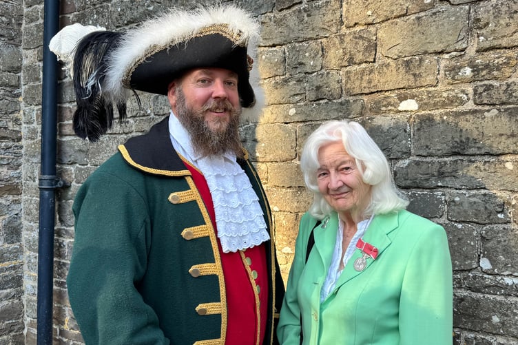 Chulmleigh Town Crier Ben Farlam with Sylvia Gilson, who was awarded a BEM for Services to Chulmleigh Fair in 2014. AQ 6756