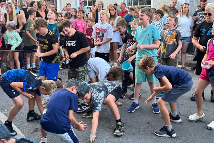Children taking part in the traditional money scramble at Chulmleigh Fair. AQ 6852