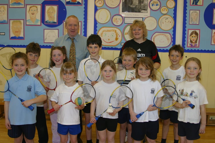 Sandford School head teacher Wilson Forster, with Sharon Hawkins, badminton development officer, with some of the children who enjoyed one of the courses at the school in March 2005. 247-4729_IMG