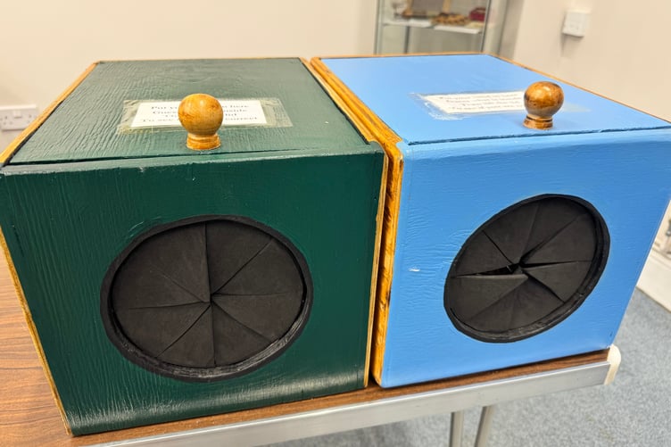 Children are invited to guess what is in the boxes at Crediton Museum. AQ 8653