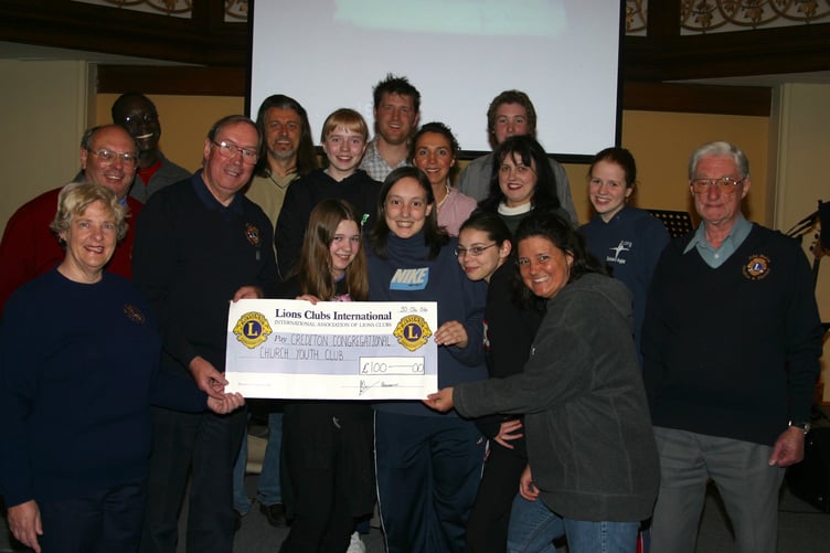 Eric Parkes, Crediton Lions President, presents £100 to Crediton Congregational Church X5 Youth Club, with Lions members Rev Jerry Crosby and youth director Jacqui Crosby in May 2004. 184-8481_IMG