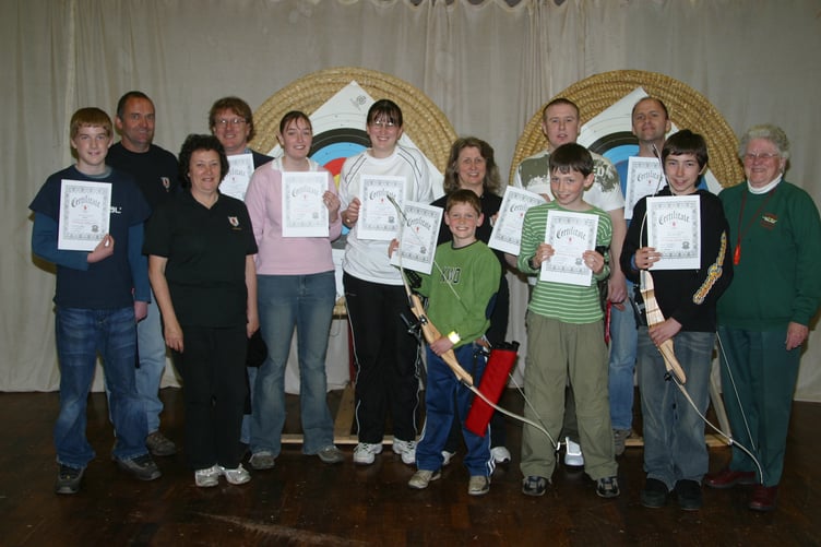 A group of people who completed an introductory archery course with certificates received from Kyrton Archers' chairman Alison Staddon, centre right, in May 2005. 262-6236_IMG
