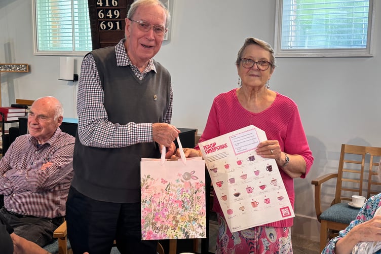 Eric Parkes was the winner of the Breast Cancer Now Teacup Challenge, receiving his prize from Bronwyn Nott. AQ 9586