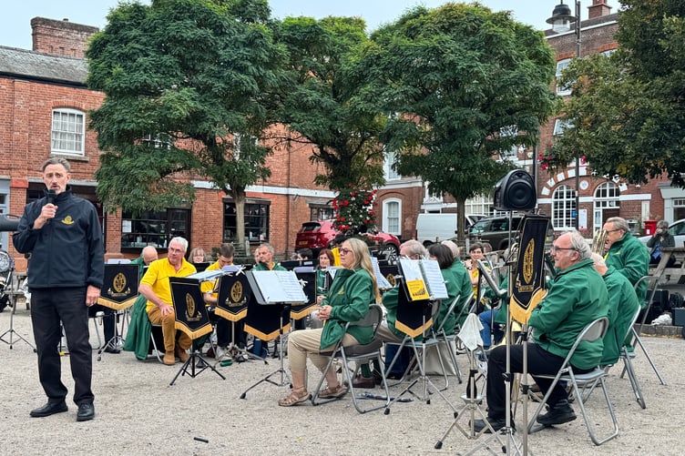 Musical Director Iorwerth Pugh introduces the next piece of music Crediton Town Band will play. AQ 0147