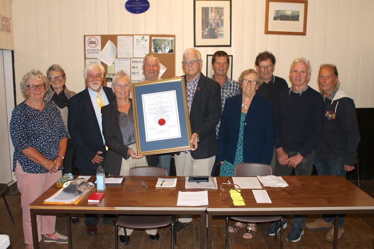 Malcolm Vallance receiving his Certificate of Outstanding Achievement from Cllr Gwen DuChesne MBE with Thelbridge Parish Councillors, District Councillors Polly Colthorpe and Steve Keable, with former District Councillor Margaret Squires and a Sandford Parish Councillor. AQ 2141
