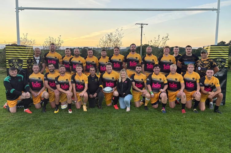 Front, centre left, Rob Campbell and centre right, Claire Sharp of Kis, kit sponsors with the North Tawton team.