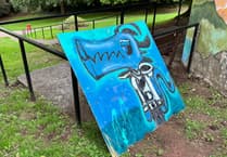 Graffiti art ripped from toilet block wall