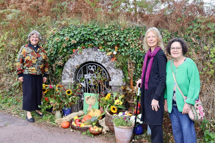 From left, Rev Sandra Collier, who gave the blessing at the holy well, and Joy Moore and Fredérique Cooke who decorated it