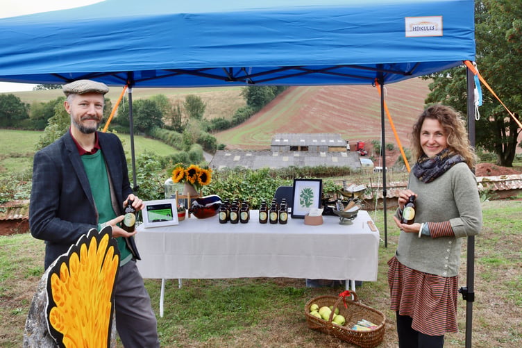 12 September 2026 Shobrooke Harvest Festival New Shobrooke residents Alex and Ania showed off their nettle-infused apple cider vinegar tonic 'The Tingling Nettle' (Will Goddard, Crediton Courier)