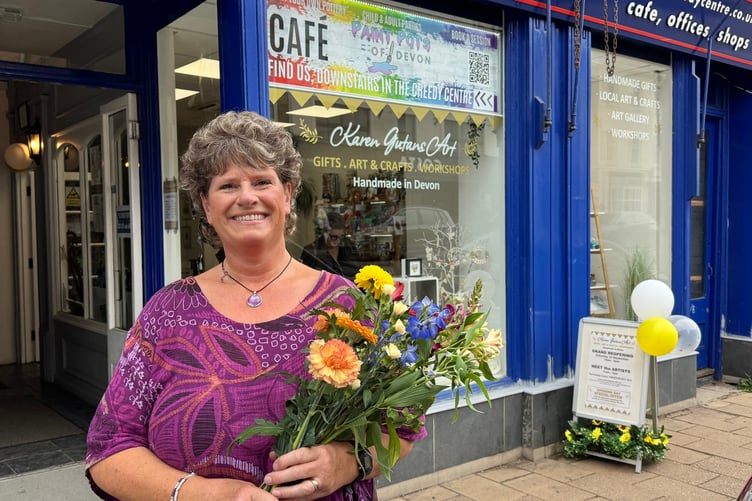 Karen Gutans with flowers she received after opening her new large gallery at The Creedy Centre. AQ 0805