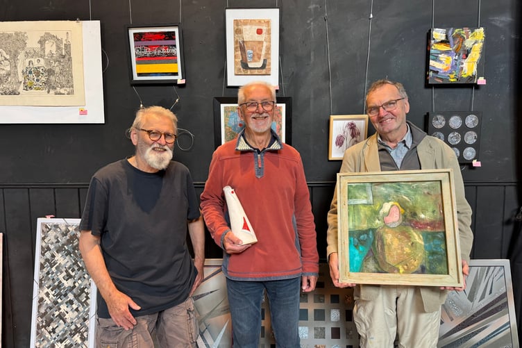 Artists Tim Salter, Girts Gailans and Robert Joyce with some of their art they donated for the Gaza Art Aid event. AQ 0839