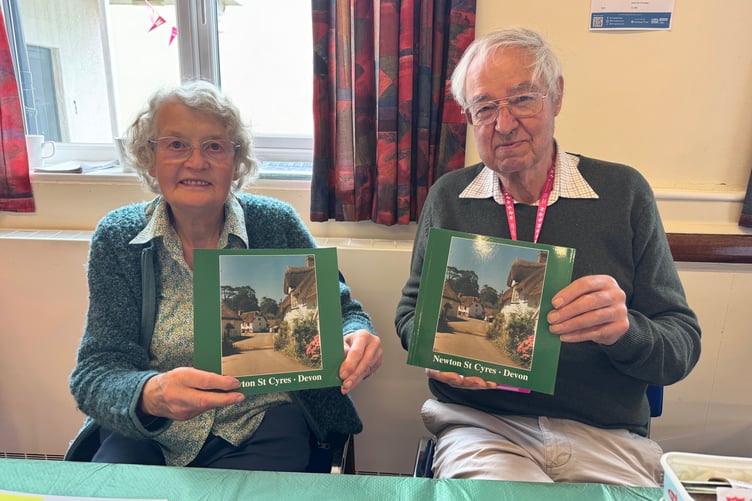 Jean and Roger Wilkinson with copies of the book about the history of Newton St Cyres, available from Crediton Museum for £5. AQ 1218