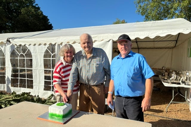 Julie Davie secretary, Chris Norman president and Ross Hext chairman, cut the 80th celebration cake at Cheriton Fitzpaine Ploughing Match.
